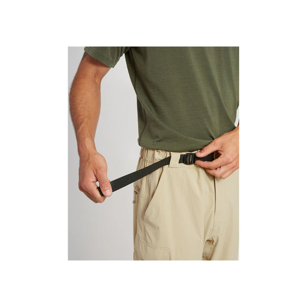 Sand | XTM Sturgeon Zip Off Hike Pant Image Showing Model Adjusting The Built In Belt.