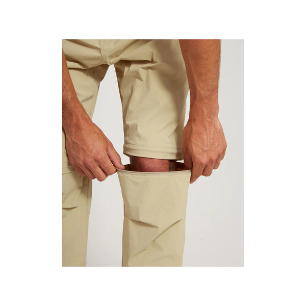 Sand | XTM Sturgeon Zip Off Hike Pant Image Showing Pant Leg Being Zipped Off.