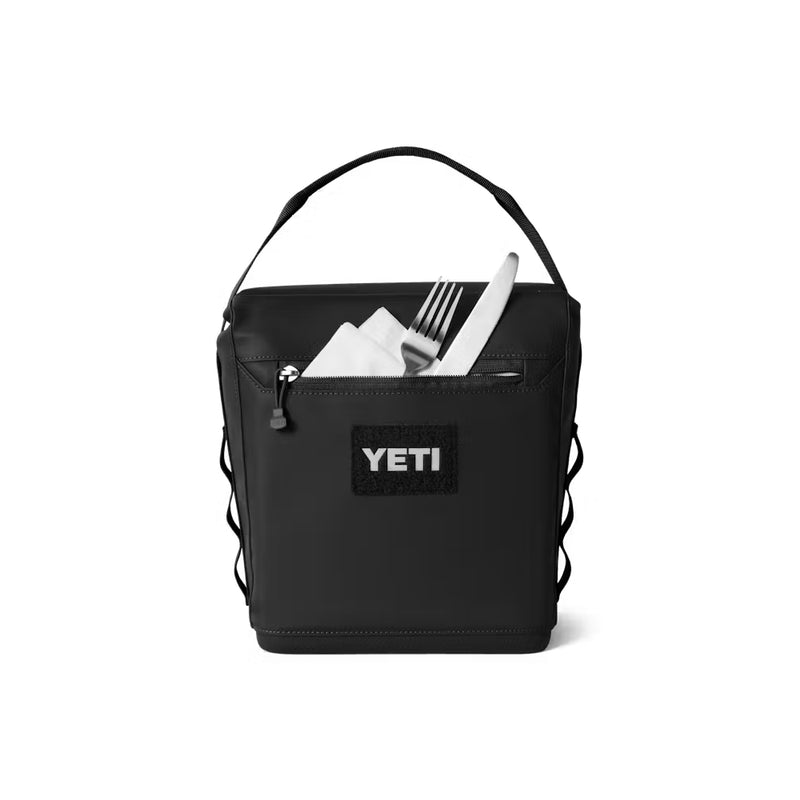 Black / 6L | YETI Daytrip Insulated Lunch Bag Image Showing Front View, With Cutlery In The Front Zippered Pocket.