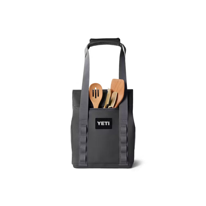 Charcoal / 14L | YETI Daytrip Insulated Tote Bag Image Showing Back View, Zippered Pocket Being Used To Hold Utensil's Needed For A Day Out And About.
