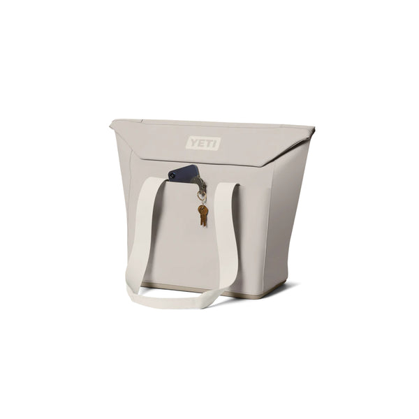 Cape Taupe | YETI Daytrip Insulated 20L Tote Bag Image Showing Angled Front View With Pocket In Use.
