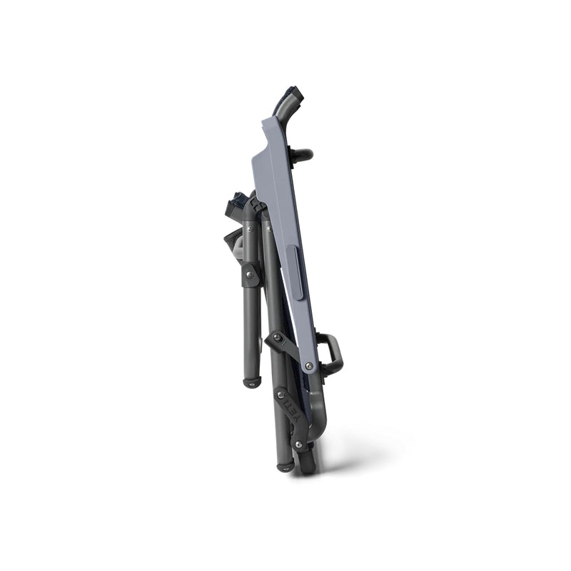 Navy | YETI Hondo Beach Chair Image Showing Side View Of Chair Folded Down For Easy Storage And Transportation.