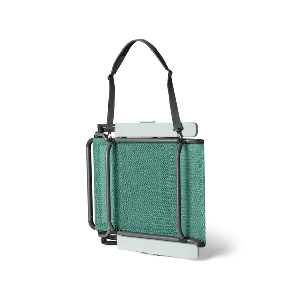 Seafoam | YETI Hondo Beach Chair Image Showing Side View Of The Chair Folded Down, With Carry Strap Attached.