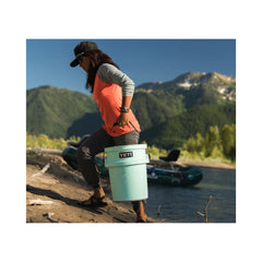 SeaFoam | YETI Loadout Bucket Image Showing A Model Using The Bucket To Carry Water.