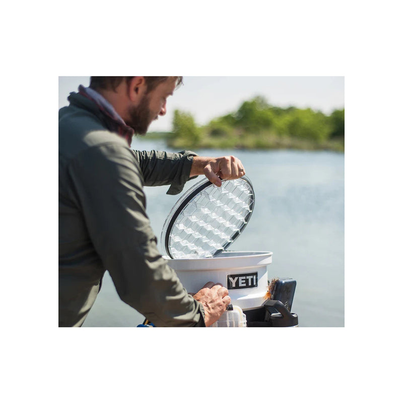 Clear | YETI Loadout Bucket Image Showing Model Opening Lid Out On The Lake.