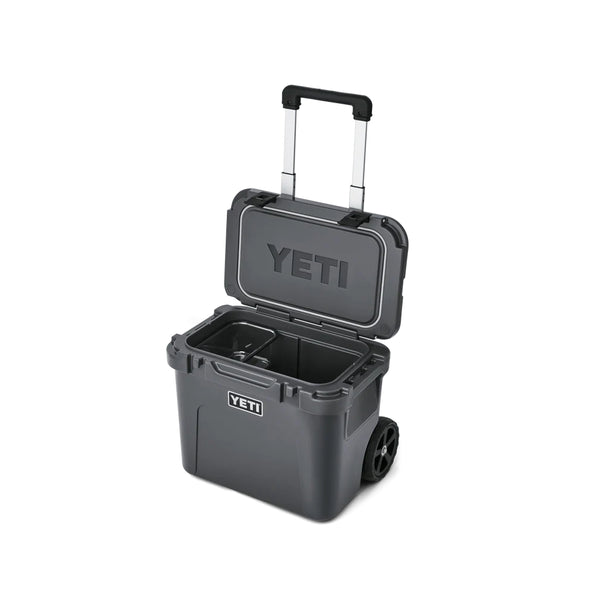 Charcoal | YETI Roadie 32 Wheeled Hard Cooler Image Showing Angled Front View, With Lid And Handle Up.