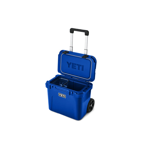 Royal Blue | YETI Roadie 32 Wheeled Hard Cooler Image Showing Angled Front View, Lid And Handle Up.