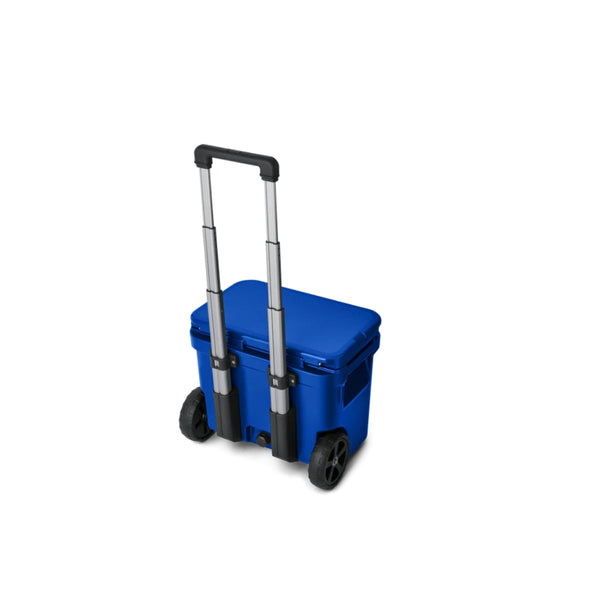 Royal Blue |YETI Roadie 32 Wheeled Hard Cooler Image Showing Angled Back View, Lid Down Handle Up.