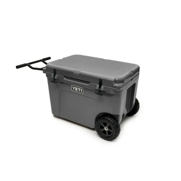 Charcoal | YETI Tundra Haul Wheeled Hard Cooler Image Sowing Angled Front View, With Handle Out.
