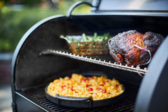 Smoker in use with roast meat and vegies.