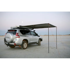 Awning attached to a silver Prado and set up