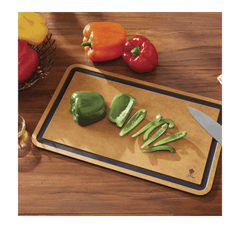 Lifestyle image of cutting board being used to cut green capsicum