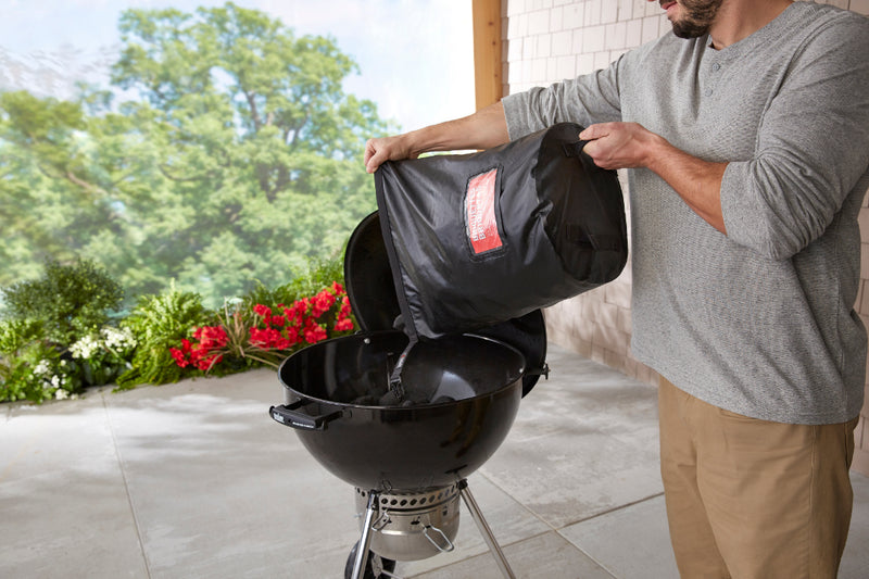 Pouring Coals into Kettle BBQ From Fuel Bag