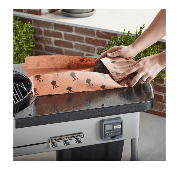Person wrapping piece of meat in butcher paper
