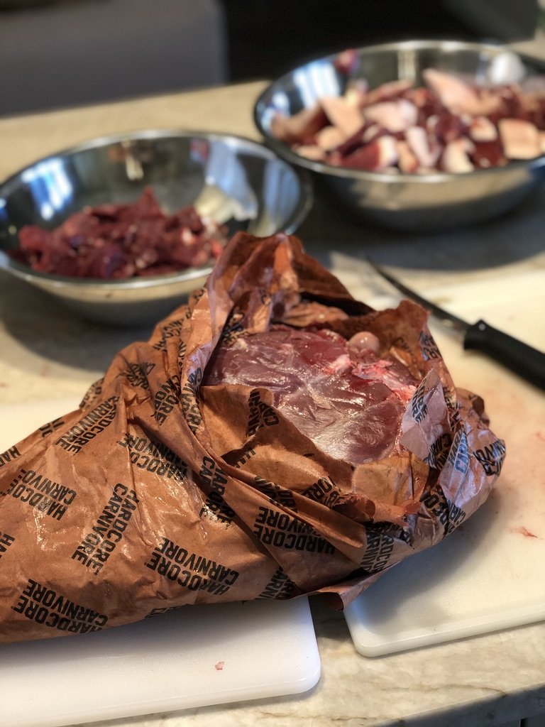 Partially unwrapped meat in paper
