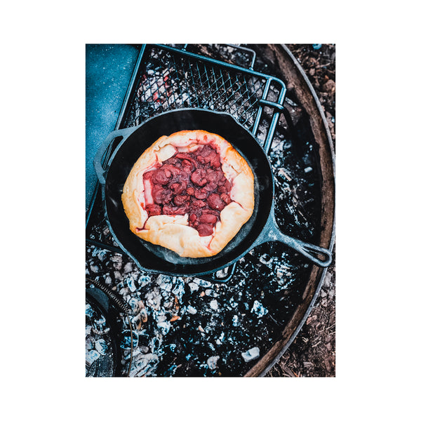 Skillet in Use Cooking a Berry Pie on Campfire. 