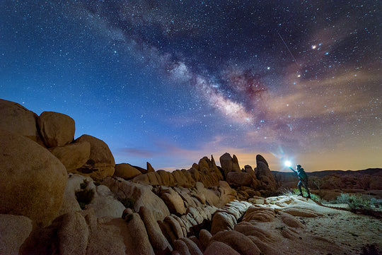 Lantern being used in the distance by some rocks