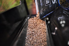 Close up of pellet hopper being filled.