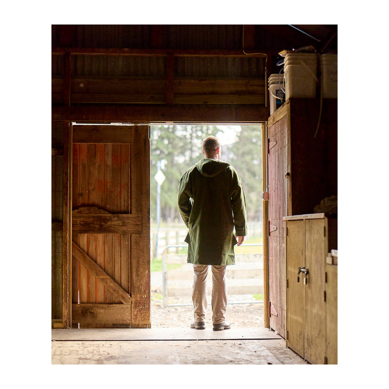 Olive | Swanndri Original Lace Front Bush Shirt - Back View Looking Out Of Shed. 