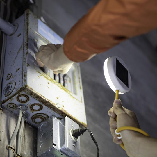 Light in use with someone at a electrical meter box