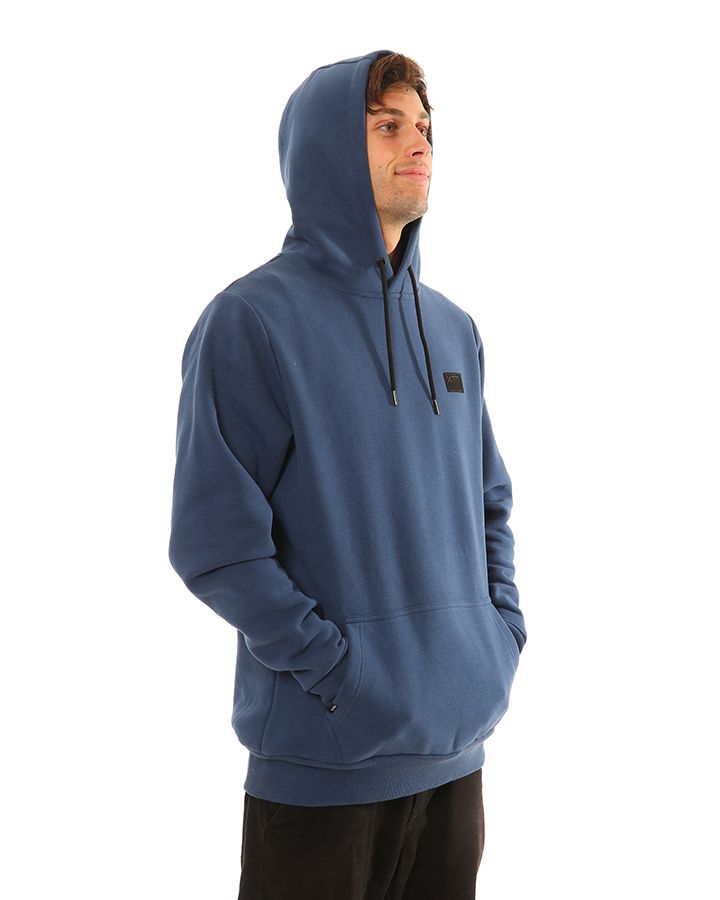 Navy | Side View with Hood on, hands in pocket. Male Model